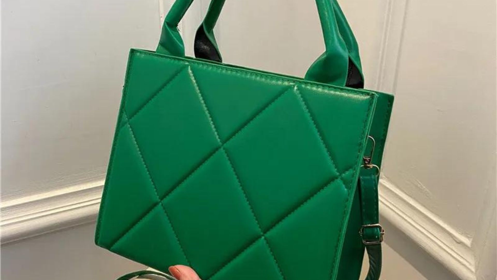 a green hand bag showing fashion bags